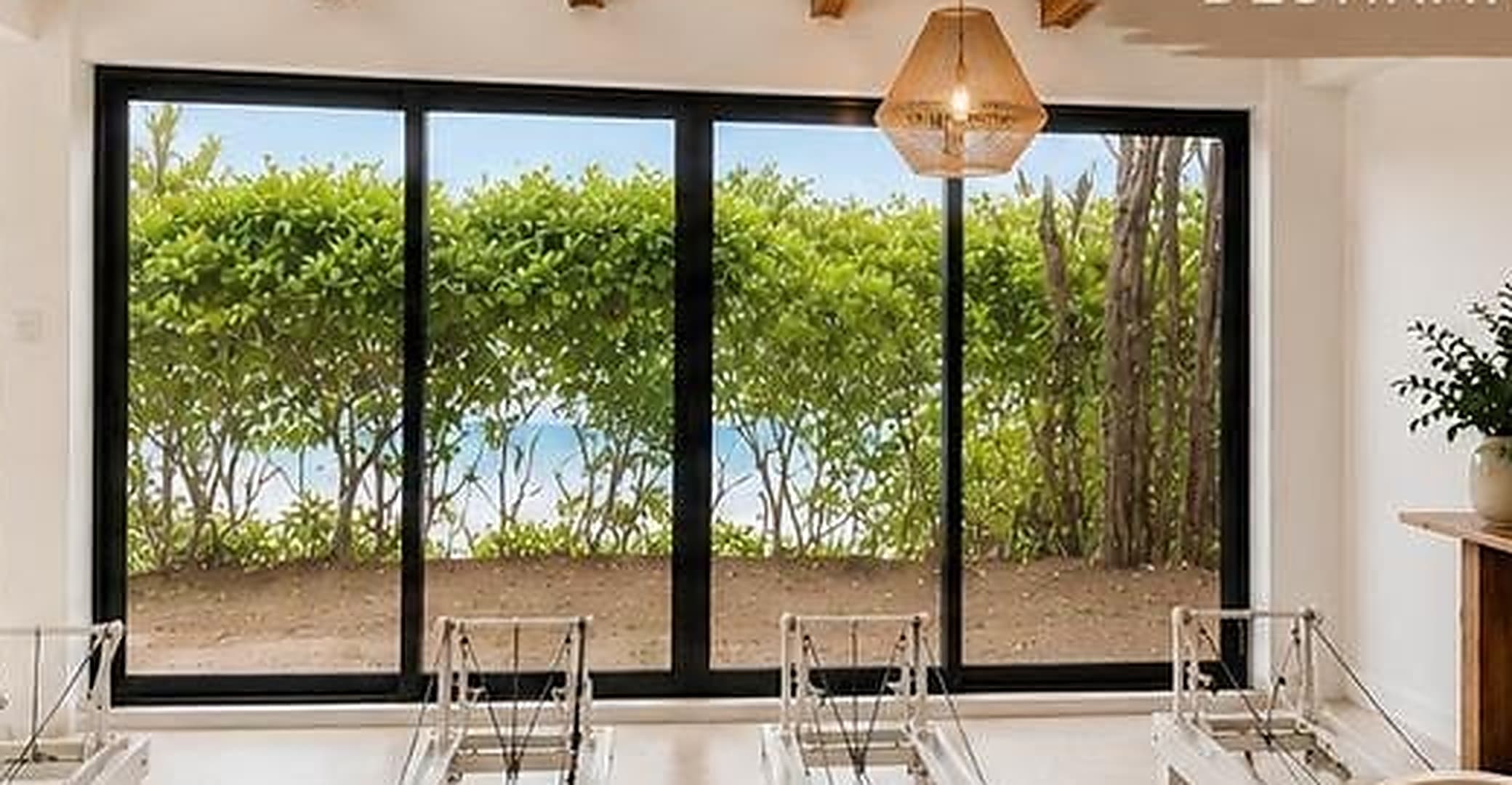 Oceano reformer studio with garden and ocean beyond the windows